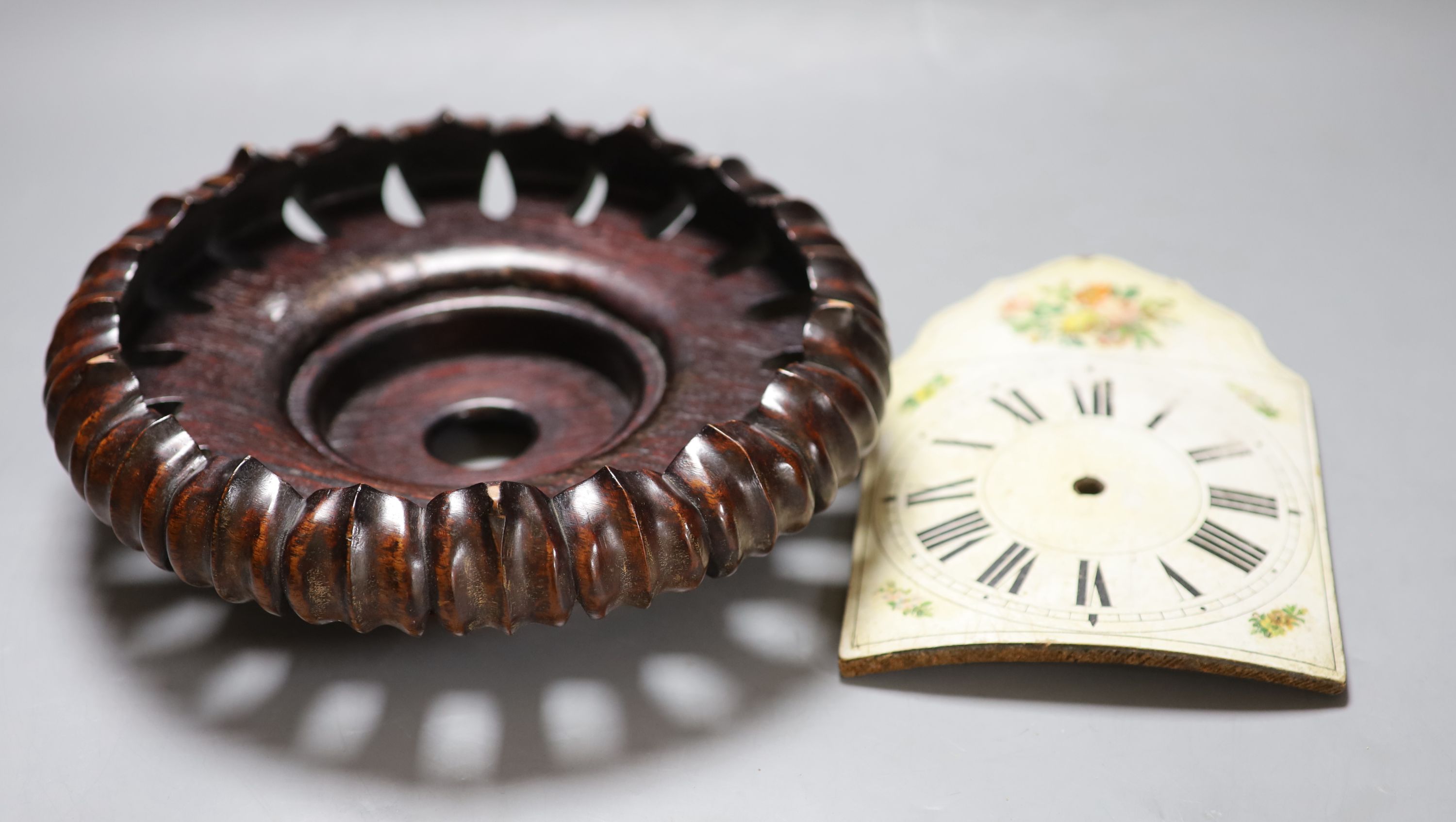 A Chinese hardwood stand, late Qing, diameter 25cm, together with a Swedish painted wood clock dial